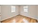 Cozy bedroom with hardwood floors, two windows, and neutral paint at 970 Lima St, Aurora, CO 80010