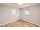 Bright bedroom with hardwood floors, two windows, and neutral paint at 970 Lima St, Aurora, CO 80010