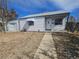 Charming single-story home featuring white siding, awning, and a well-maintained front yard at 970 Lima St, Aurora, CO 80010
