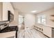 Bright kitchen with stainless steel appliances and stylish gray floors for a modern look at 970 Lima St, Aurora, CO 80010