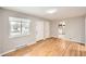 Inviting living room featuring hardwood floors, a large window, and a view into the kitchen at 970 Lima St, Aurora, CO 80010