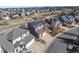 Aerial view of a suburban home with solar panels and a three car garage at 395 Winterthur Way, Highlands Ranch, CO 80129