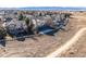 Scenic aerial view of a suburban home with a spacious yard, white fence, and a walking path at 395 Winterthur Way, Highlands Ranch, CO 80129