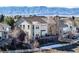 Backyard featuring a large deck perfect for entertaining; snow patch and view of mountains in the distance at 395 Winterthur Way, Highlands Ranch, CO 80129