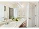 Bright bathroom featuring dual sinks, tile floors, and a decorative mirror at 395 Winterthur Way, Highlands Ranch, CO 80129