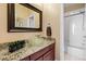 Bathroom featuring granite countertops and a modern glass bowl sink at 395 Winterthur Way, Highlands Ranch, CO 80129