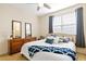 Bedroom featuring a queen bed, ceiling fan, and decorative mirrors at 395 Winterthur Way, Highlands Ranch, CO 80129