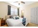 Comfortable bedroom with soft lighting, a ceiling fan, and a view into an ensuite bathroom at 395 Winterthur Way, Highlands Ranch, CO 80129