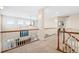 Bright hallway with wood trim, neutral carpet, and many windows at 395 Winterthur Way, Highlands Ranch, CO 80129