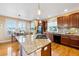 Well-lit kitchen with granite countertops, stainless steel appliances, and hardwood floors at 395 Winterthur Way, Highlands Ranch, CO 80129