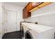 Well-equipped laundry room with cabinets and a utility sink at 395 Winterthur Way, Highlands Ranch, CO 80129