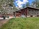 Spacious backyard with a hot tub, patio area, and beautiful landscaping perfect for outdoor living at 720 N Bluff Dr, Franktown, CO 80116