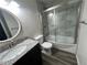 Bathroom with shower with glass doors, dark vanity, and speckled countertops at 9762 Appletree Pl, Thornton, CO 80260