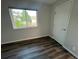 Bedroom featuring wood-look floors, a window, and a white door at 9762 Appletree Pl, Thornton, CO 80260