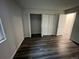 This bedroom features wood flooring and an ample closet space at 9762 Appletree Pl, Thornton, CO 80260