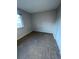 Bright bedroom featuring neutral walls, carpet flooring, and a window letting in natural light at 9762 Appletree Pl, Thornton, CO 80260