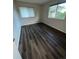 Bedroom featuring hard flooring, window with blinds, and large window at 9762 Appletree Pl, Thornton, CO 80260