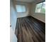 Bedroom featuring hard flooring, window with blinds, and large window at 9762 Appletree Pl, Thornton, CO 80260