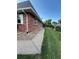 This exterior features a walkway, a green lawn, and brick at 9762 Appletree Pl, Thornton, CO 80260