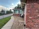 This exterior features brick, a satelite dish, and lawn at 9762 Appletree Pl, Thornton, CO 80260