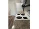 White electric stove top next to speckled granite countertops in a kitchen setting at 9762 Appletree Pl, Thornton, CO 80260
