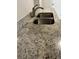 Close up of a stainless steel double sink, with a granite countertop, and a modern faucet at 9762 Appletree Pl, Thornton, CO 80260