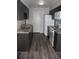 Modern kitchen featuring granite countertops, new appliances, and hardwood floors at 9762 Appletree Pl, Thornton, CO 80260