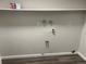 Unfinished laundry room with laminate flooring and hookups at 9762 Appletree Pl, Thornton, CO 80260