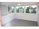Bright sunroom with carpet, multiple windows, and modern blinds at 9762 Appletree Pl, Thornton, CO 80260