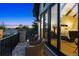 This balcony view reflects the interior primary suite with seating and gorgeous twilight view at 1118 Northwood Ln, Castle Rock, CO 80108