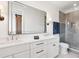 Modern bathroom with double vanity, quartz countertops, and a glass-enclosed shower with gray tiling at 1118 Northwood Ln, Castle Rock, CO 80108