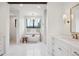 This elegant bathroom features a soaking tub, decorative light fixture, and tiled walls at 1118 Northwood Ln, Castle Rock, CO 80108