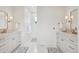 Bright bathroom with double vanity, marble floors, soaking tub and ample lighting at 1118 Northwood Ln, Castle Rock, CO 80108