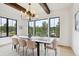 Bright dining room featuring a large window with views, modern chandelier, and seating for eight at 1118 Northwood Ln, Castle Rock, CO 80108