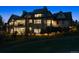 Elegant two-story home with multiple balconies, visible in the evening, and landscaped surroundings at 1118 Northwood Ln, Castle Rock, CO 80108