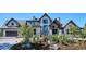 Charming home with stone and wood details, complemented by lush landscaping and a well-maintained garden at 1118 Northwood Ln, Castle Rock, CO 80108