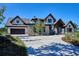 Beautiful home exterior featuring stone accents, a covered entry, and a spacious driveway on a sunny day at 1118 Northwood Ln, Castle Rock, CO 80108