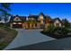 Lovely exterior of home shows front yard, circular driveway, elegant landscaping, and mountain views at 1118 Northwood Ln, Castle Rock, CO 80108