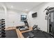 Bright home gym featuring modern equipment, a wall-mounted TV, and a mirrored wall at 1118 Northwood Ln, Castle Rock, CO 80108