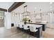 Spacious kitchen with dual islands, sleek countertops, white cabinetry, and modern pendant lighting at 1118 Northwood Ln, Castle Rock, CO 80108