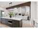 Island with stainless steel microwave drawer in an open kitchen and living room floor plan with stone fireplace at 1118 Northwood Ln, Castle Rock, CO 80108