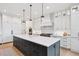 Elegant kitchen with a large center island, sleek cabinetry, and modern pendant lighting at 1118 Northwood Ln, Castle Rock, CO 80108