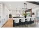 Bright, modern kitchen with a large island, white cabinetry, and stainless steel appliances, perfect for cooking at 1118 Northwood Ln, Castle Rock, CO 80108