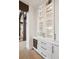 Kitchen with glass front cabinets, a wine fridge, and marble countertops, leading into dining area at 1118 Northwood Ln, Castle Rock, CO 80108