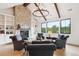 Inviting living room with stone fireplace, vaulted ceiling, exposed beams, and lots of seating at 1118 Northwood Ln, Castle Rock, CO 80108