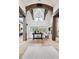 Airy living room with high ceilings, rustic beams, a stone fireplace, and views of the outdoors at 1118 Northwood Ln, Castle Rock, CO 80108