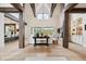 Bright, open living room featuring exposed beams, a stone fireplace, and large windows with scenic views at 1118 Northwood Ln, Castle Rock, CO 80108
