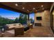 Cozy covered patio with comfortable seating, heaters, and a serene view of the surrounding landscape at twilight at 1118 Northwood Ln, Castle Rock, CO 80108