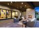 Inviting outdoor patio with a stone fireplace, comfortable wicker furniture, and access to indoor living spaces at 1118 Northwood Ln, Castle Rock, CO 80108