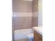 Bathroom featuring a tiled shower and tub combo, with neutral colors and functional fixtures at 10742 E Exposition Ave # 124, Aurora, CO 80012